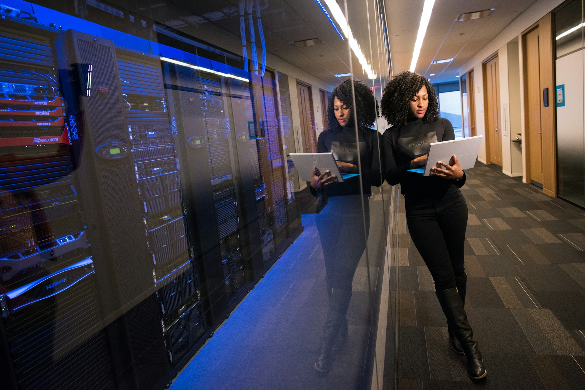 a woman next to a data center